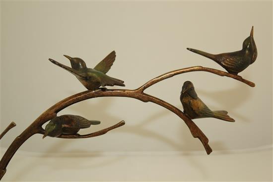 A 1920s French patinated bronze group of four birds upon a branch, L.14in.